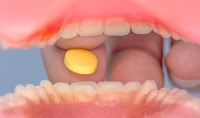 Man taking pills for depression. Old man swallowing pill