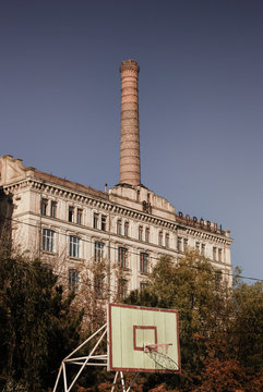 Old mill landmark building with a basketball panel in front on the Danube shore.