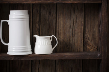 white kitchen dishware on old dark wooden background