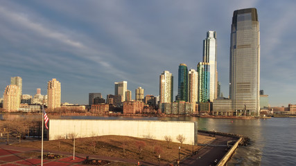Obraz premium 911 Memorial at Liberty State Park with Jersey City skyline in the background in golden light.