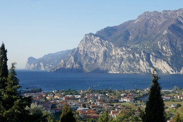 Fototapeta na wymiar View of Torbole and the mountains on the shores of Lake Garda. Torbole am is a popular vacation spot in Northern Italy.