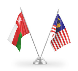 Malaysia and Oman table flags isolated on white 3D rendering