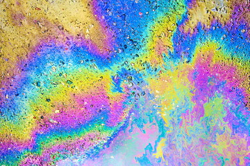 Petrol on the asphalt a big polluted puddle water.