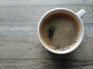 cup of coffee on wooden table