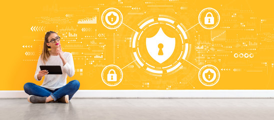 Cyber security theme with young woman holding a tablet computer