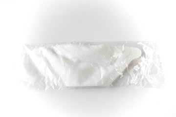 Disposable medical respiratory mask in plastic bag against virus