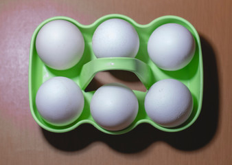 eggs in bowl on wooden background
