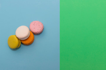 Heap of four multi-colored macaroon on flat background