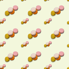 Seamless pattern heap of four multi-colored macaroon on light background