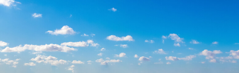 Obraz premium White small curly clouds in the blue sky_