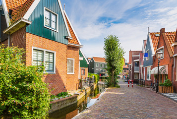 Fototapeta na wymiar Old streets in Volendam, old traditional fishing village, typical wooden houses architecture