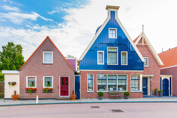 Old streets in Volendam, old traditional fishing village, typical wooden houses architecture
