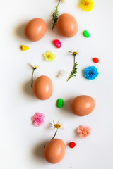 Fototapeta na wymiar Easter pattern of Eggs with flowers and candies on the white background. Easter concept. Healthy feeding concept. 