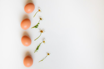 Easter pattern of Eggs with flowers  on the white background. Easter concept. Healthy feeding concept. 