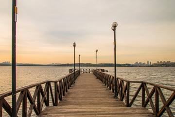 Fototapeta na wymiar Romantic wooden walkway on the lake