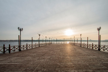 Fototapeta na wymiar Romantic wooden walkway on the lake