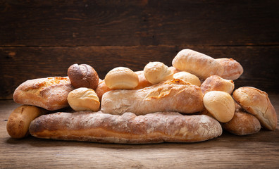Fresh baked bread  on a wooden background