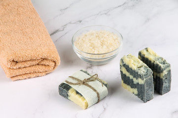 Soap, salt and a towel on a marble surface. Body care.