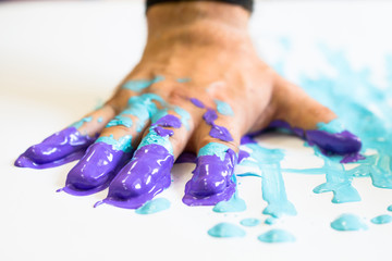 Fingers and hand dipped in colorful paint as handmade creativity and art concept, artist, painter, decorater, hobby, housework and abstract background