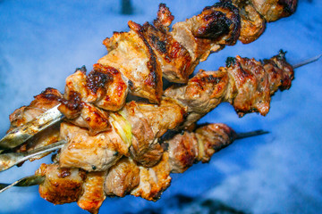meat on skewers cooked on fire, juicy kebab
