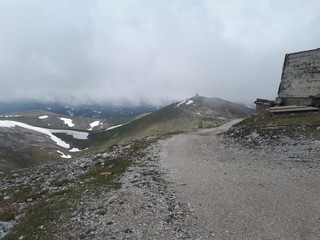Mountain panorama with clouds and snow in early summer