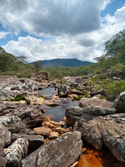 stream with stones with a mountain in the background