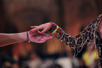 Hands of latin ballroom dancers in a movement