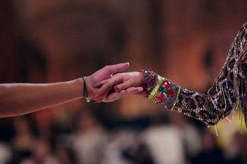 Hands of latin ballroom dancers in a movement