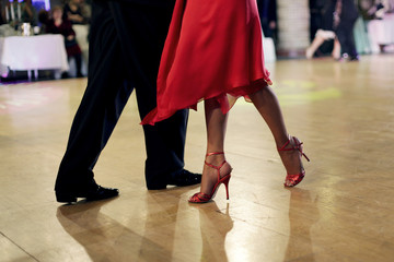 Beautiful woman in red dress dancing Argentinian tango  - obrazy, fototapety, plakaty