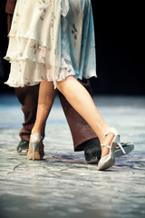 Graceful lines of legs of Argentina tango dancers