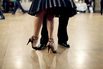 Graceful lines of legs of Argentina tango dancers