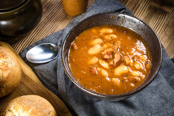 Beans with tomato sauce, bacon and sausage.