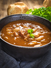 Beans with tomato sauce, bacon and sausage.