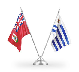 Uruguay and Bermuda table flags isolated on white 3D rendering