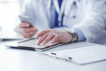 Obraz premium Portrait of senior doctor in office sitting at the desk