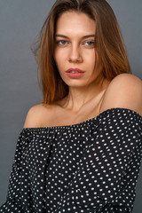 Young woman casual studio isolated on gray looking camera sensual