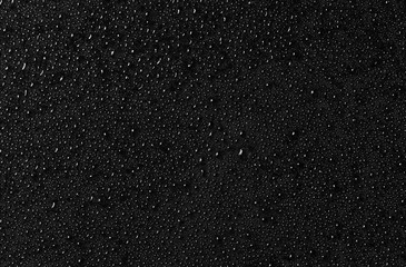Water drops on black glass surface. Texture. Top view