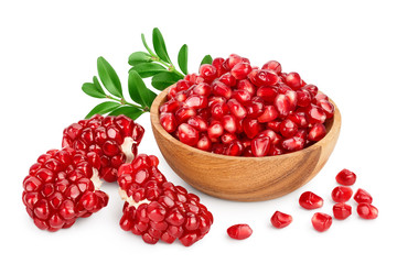 Pomegranate in wooden bowl with leaf isolated on white background with clipping path and full depth of field.