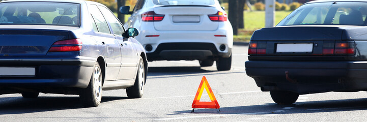 Traffic jam and symbol of forbidden movement on part of street. Automobile in slow motion. Transports driving straight. Warning of danger for drivers