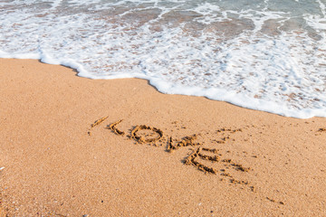 Fototapeta na wymiar I love you written on the beach