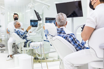 Senior man having dental treatment at dentist's office.