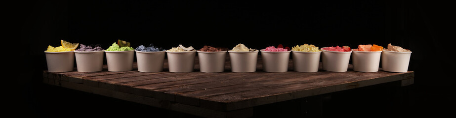 Various of ice cream flavor whit fresh blueberry, strawberry, kiwi, lemon, vanilla setup on rustic background . Summer and Sweet cold ice cream