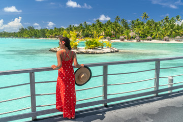 Bora Bora luxury resort vacation woman at honeymoon destination hotel by ocean beach. Bora Bora...