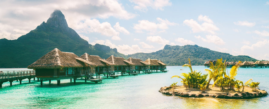 Bora Bora French Polynesia luxury hotel resort overwater bungalow suites in Tahiti, Honeymoon travel destination header panorama background.