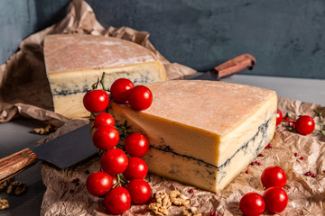 Garganzola cheese and cherry tomatoes on a blue background