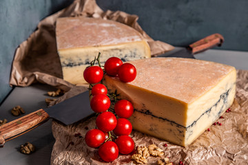 Fototapeta na wymiar Garganzola cheese and cherry tomatoes on a blue background