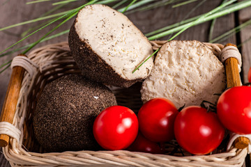Goat cheese and cherry tomatoes on a wooden table