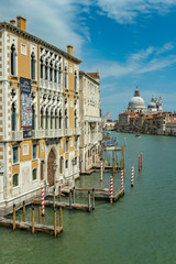 VENICE, ITALY - August 02, 2019: Grand Canal with Basilica di Santa Maria della Salute in Venice, Italy. View of Venice Grand Canal in sunny day. Architecture and landmarks of Venice