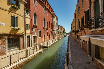 Fototapeta na wymiar VENICE, ITALY - August 03, 2019: Narrow pedestrian streets of Venice bitween the channels. Some quiet places almost without people