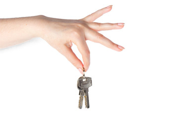 House keys in the female hand on a white background